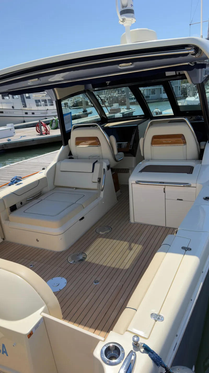Slide: The Image of The image shows the cockpit of a 2023 Chris-Craft Calypso 35 with elegant seating and wooden flooring. - 11