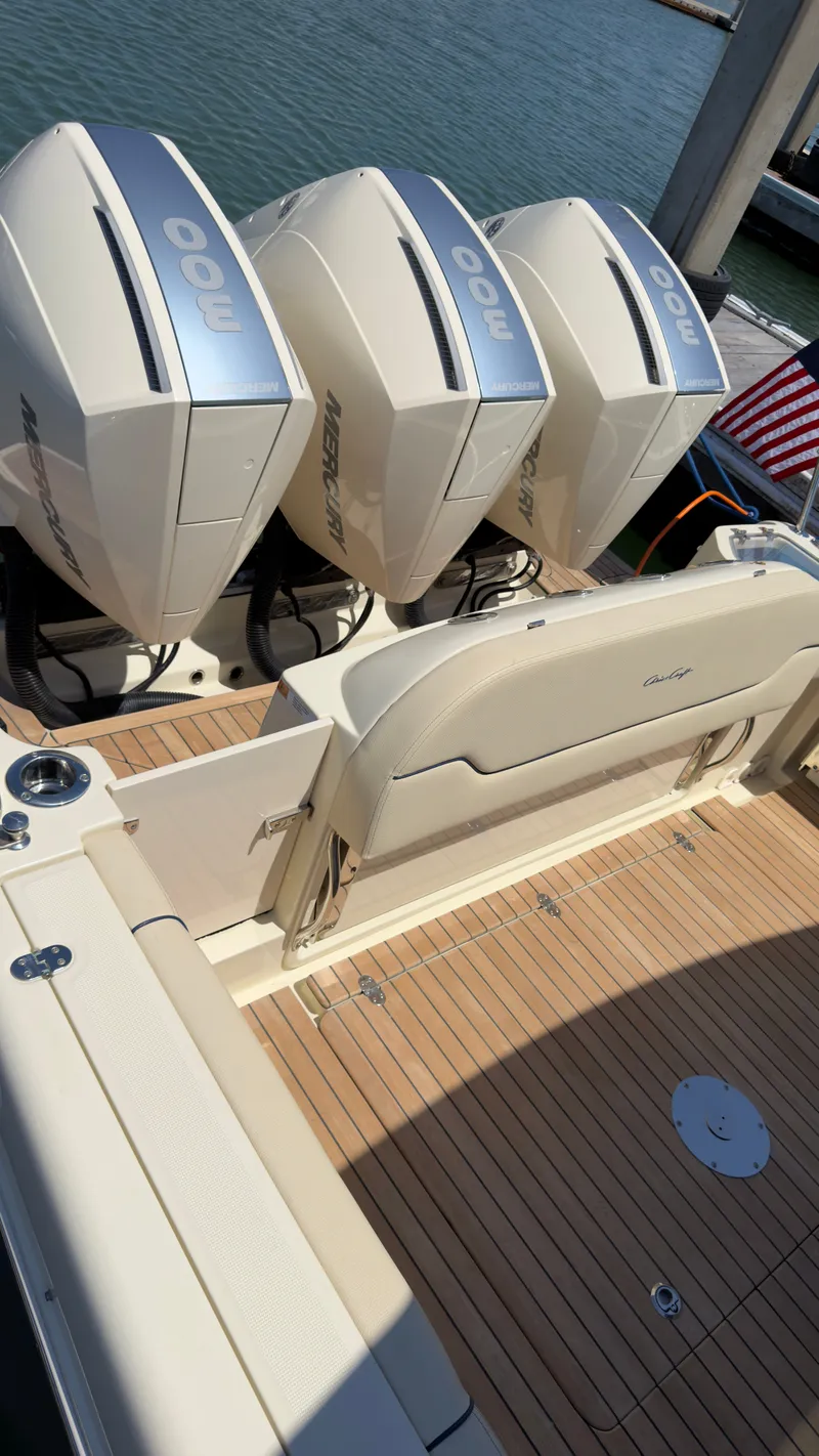 Slide: The Image of The image shows the stern of a Chris-Craft Calypso 35 with three Mercury engines. - 9