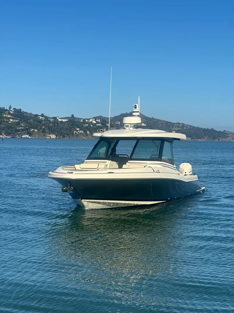 Slide: The Image of 2023 Chris-Craft Calypso 35 on calm water with hills in the background. - 15