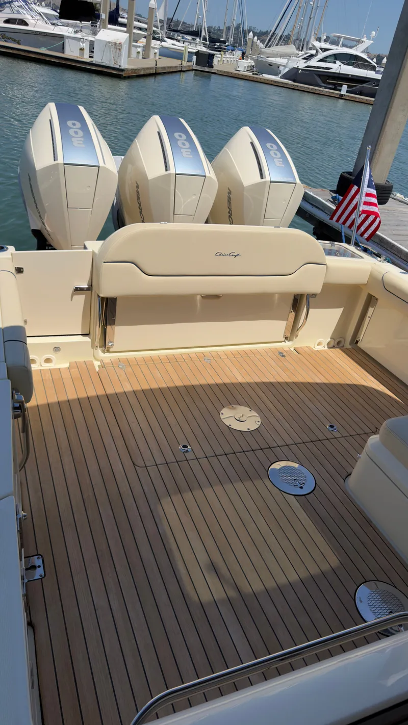 Slide: The Image of The image shows the stern of a 2023 Chris-Craft Calypso 35 boat with three outboard engines. - 10