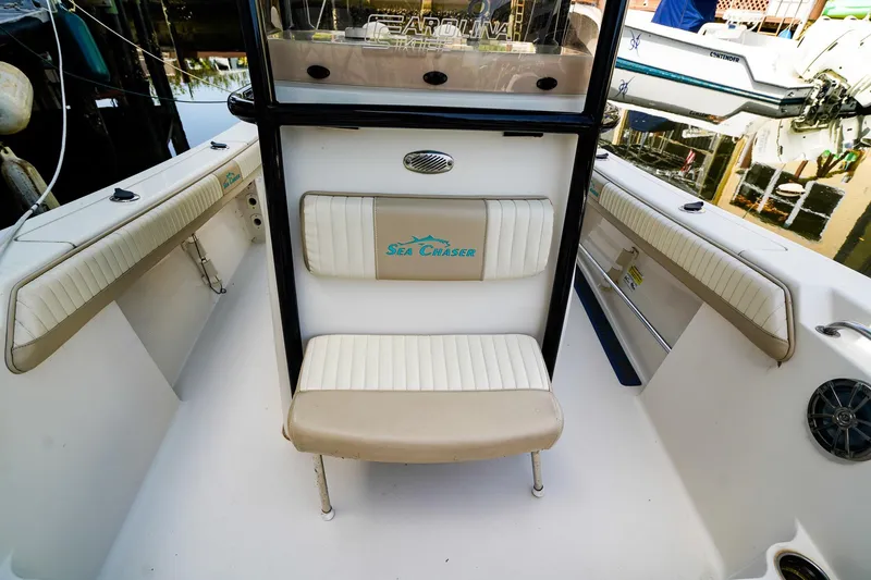 Slide: The Image of 2018 Sea Chaser 24 HFC boat interior with cushioned seating and branded logo. - 20