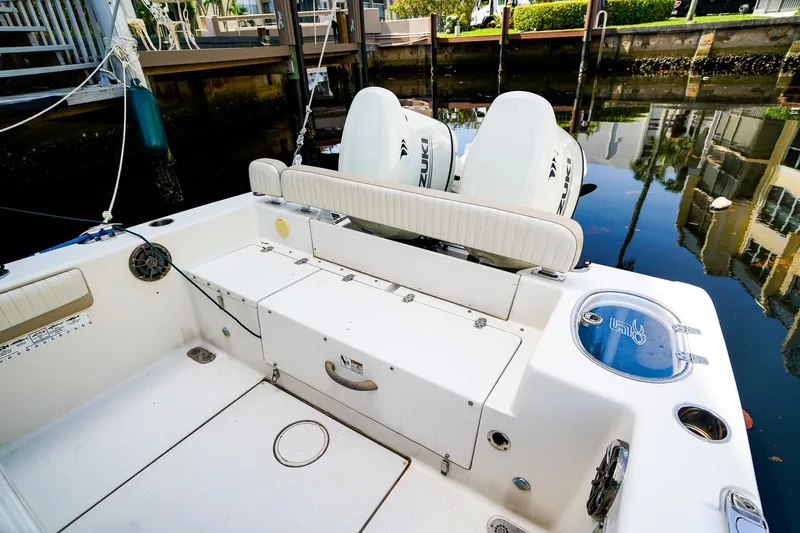 Slide: The Image of 2018 Sea Chaser 24 HFC boat with Suzuki engines docked by waterfront. - 5
