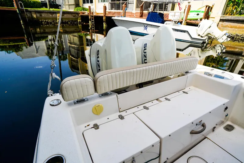 Slide: The Image of 2018 Sea Chaser 24 HFC boat with Suzuki engines docked by the water. - 6
