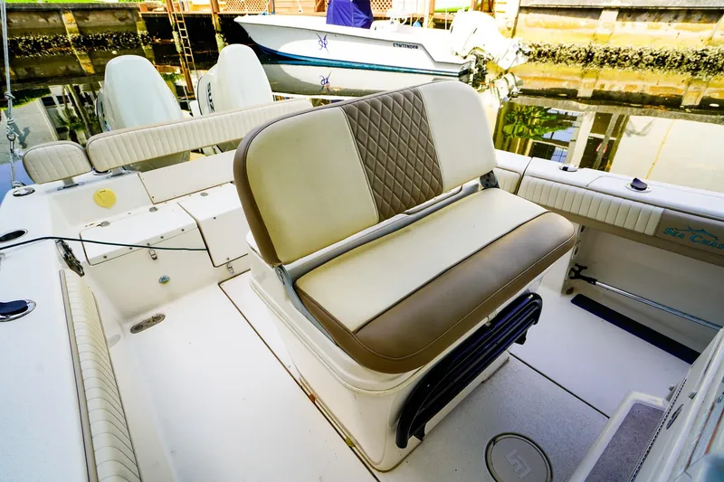 Slide: The Image of 2018 Sea Chaser 24 HFC boat interior with cushioned seating and storage compartments. - 10