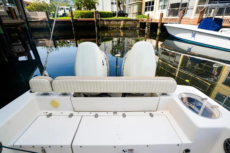 Slide: The Image of 2018 Sea Chaser 24 HFC boat with dual engines docked in a marina. - 4