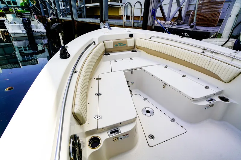 Slide: The Image of 2018 Sea Chaser 24 HFC boat interior with white seating and storage compartments. - 16