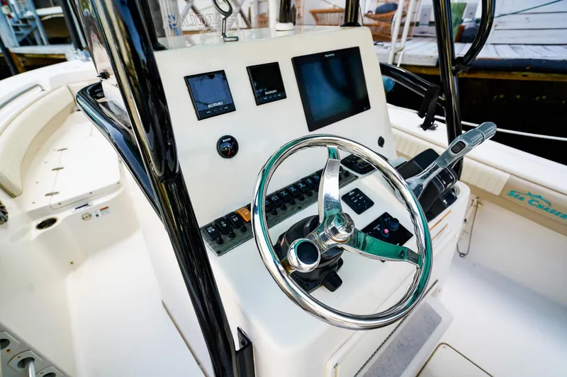 Slide: The Image of 2018 Sea Chaser 24 HFC boat helm with steering wheel and control panel. - 13
