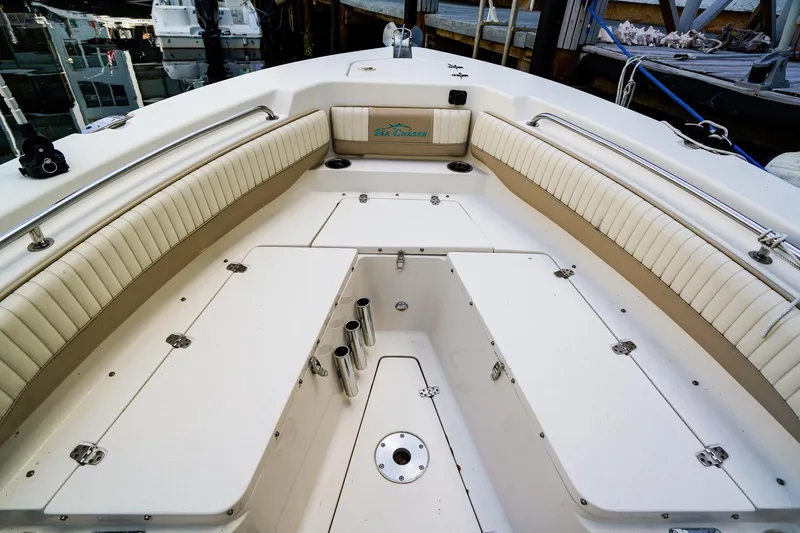 Slide: The Image of 2018 Sea Chaser 24 HFC boat interior with cushioned seating and storage compartments. - 17