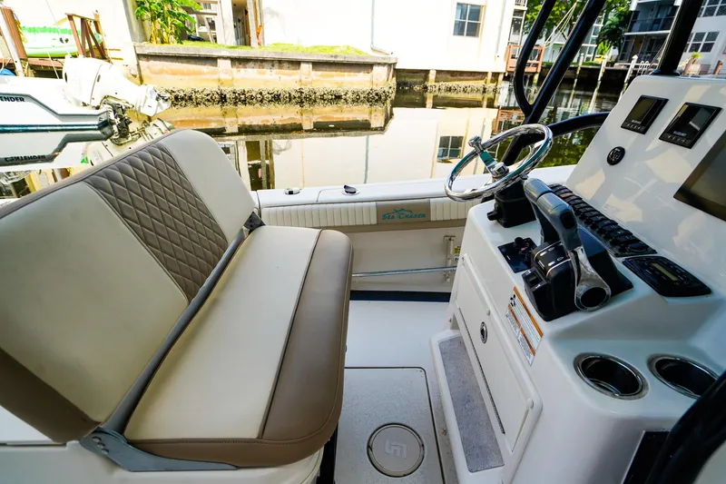 Slide: The Image of 2018 Sea Chaser 24 HFC boat interior with steering wheel and seating. - 12