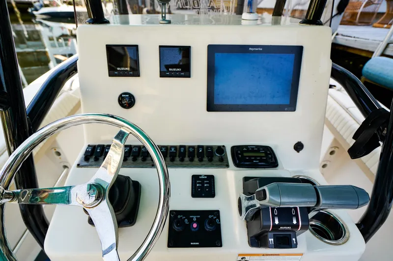 Slide: The Image of Control panel of a 2018 Sea Chaser 24 HFC boat with steering wheel and electronics. - 14
