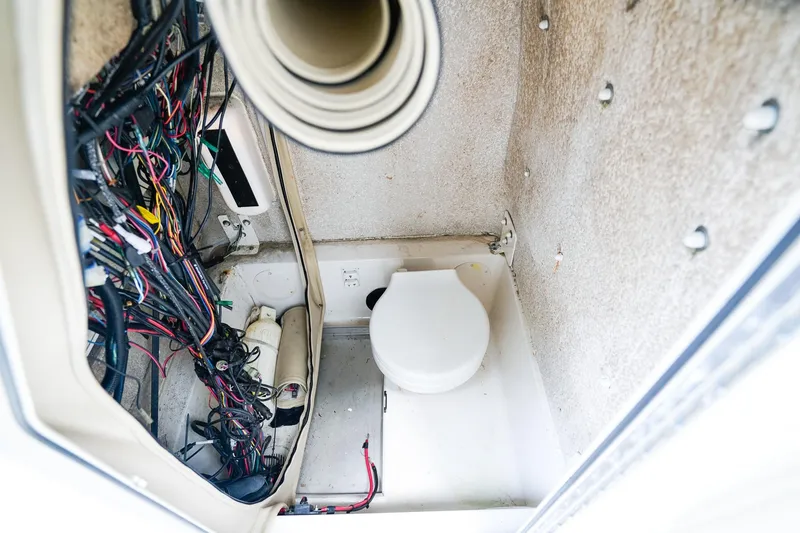 Slide: The Image of Interior of 2018 Sea Chaser 24 HFC boat showing wiring and compact toilet. - 21