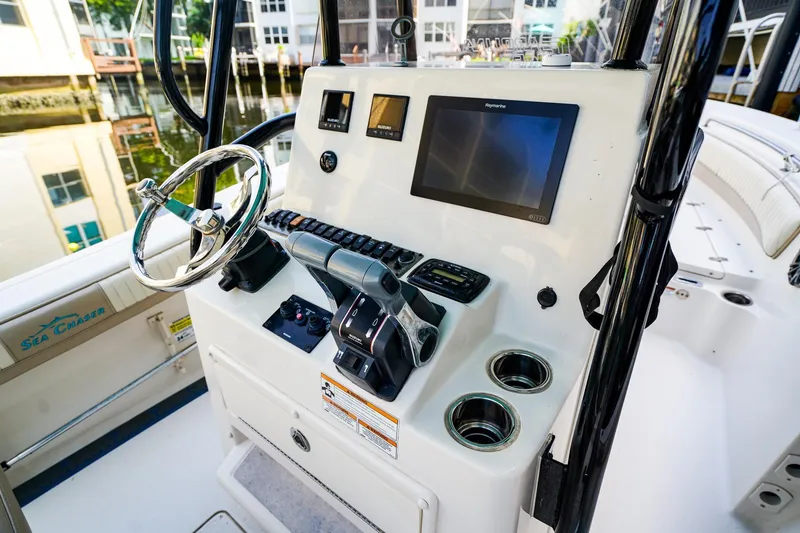 Slide: The Image of 2018 Sea Chaser 24 HFC boat dashboard with steering wheel and navigation display. - 11
