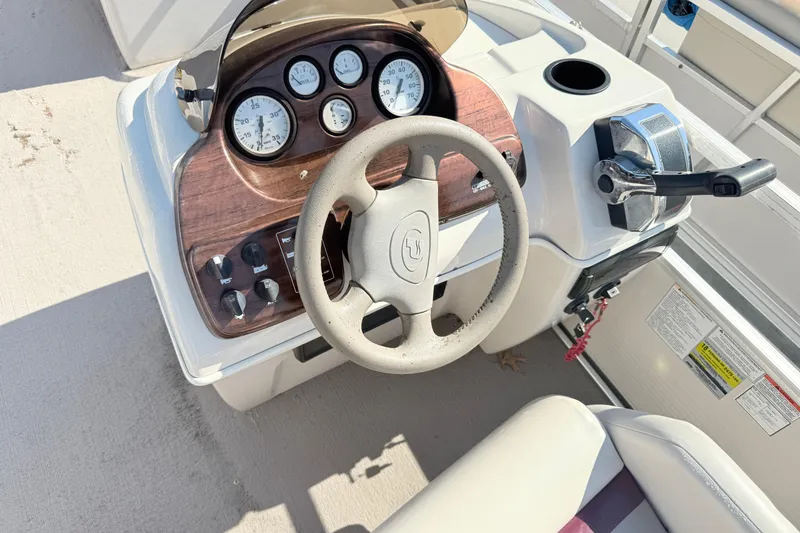 Slide: The Image of Steering console of a 2002 Princecraft Vantage 24 L boat with gauges and controls. - 9