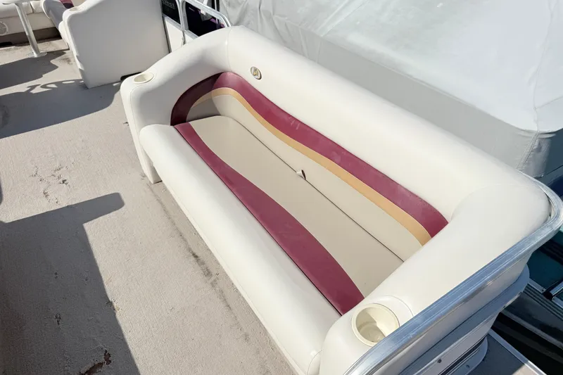 Slide: The Image of White and maroon seating on 2002 Princecraft Vantage 24 L boat, featuring cup holders. - 4