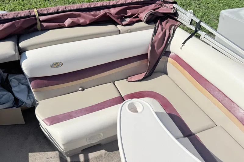 Slide: The Image of 2002 Princecraft Vantage 24 L boat interior with beige and maroon seating. - 10