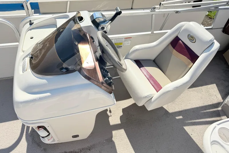 Slide: The Image of Captain's seat and console of a 2002 Princecraft Vantage 24 L boat. - 8