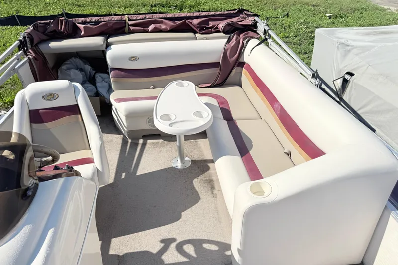 Slide: The Image of Interior of a 2002 Princecraft Vantage 24 L boat with seating and table. - 7