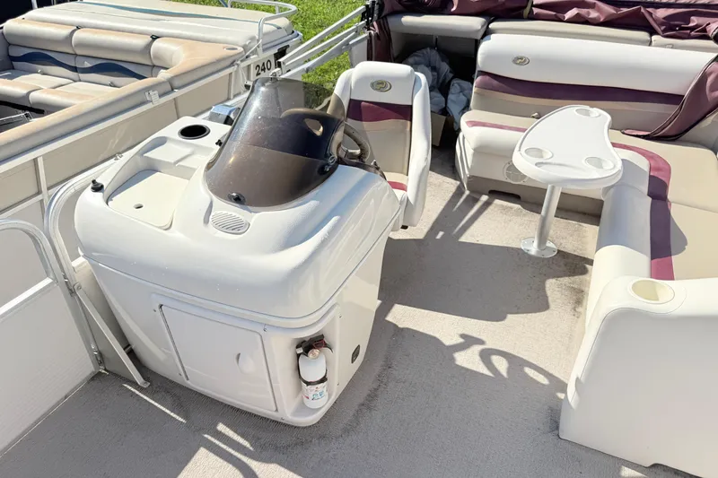 Slide: The Image of 2002 Princecraft Vantage 24 L boat interior with helm, seating, and table. - 6