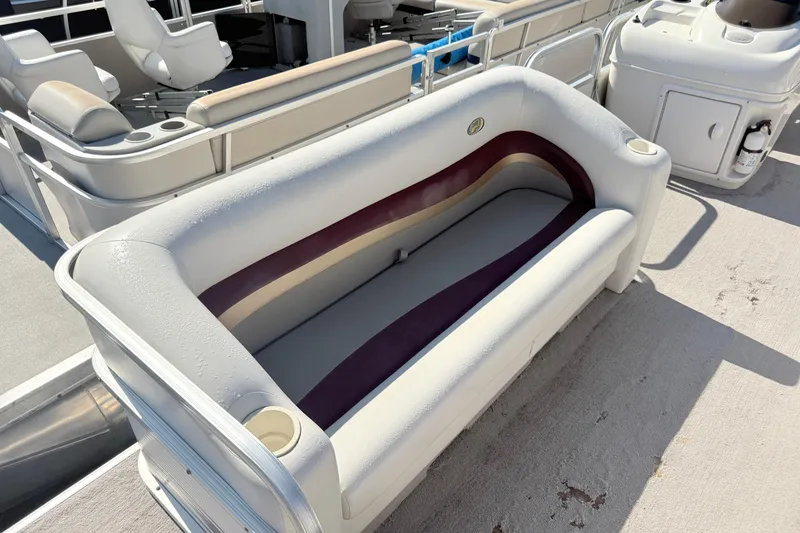 Slide: The Image of 2002 Princecraft Vantage 24 L boat interior with cushioned seating and cup holders. - 3