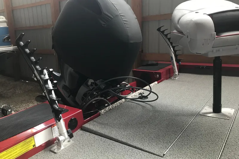 Slide: The Image of 2018 G3 Sportsman 19 boat interior with motor and seating in storage. - 4