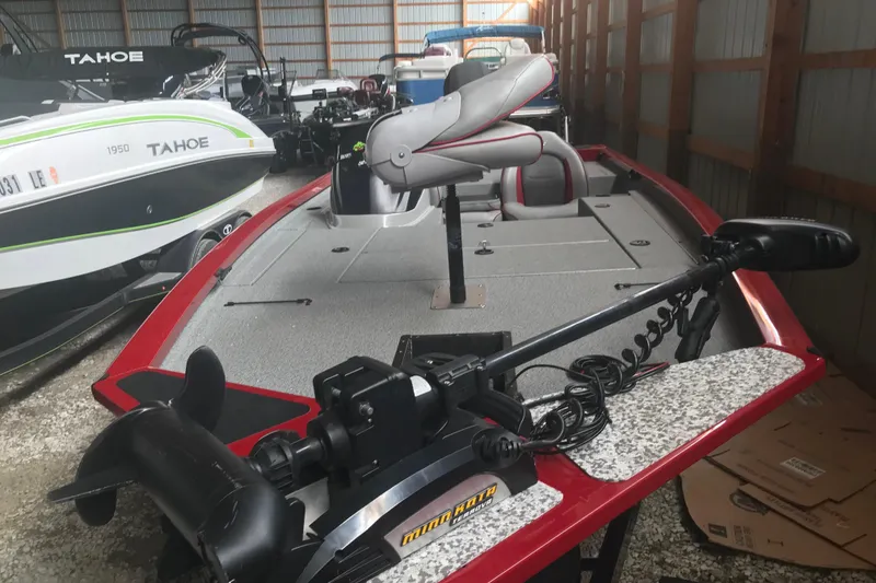 Slide: The Image of 2018 G3 Sportsman 19 boat in storage, featuring a trolling motor and seating. - 16