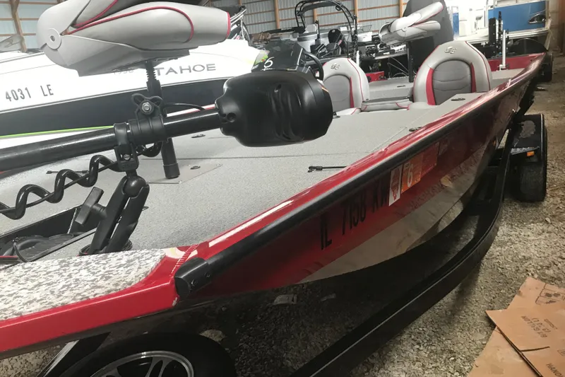 Slide: The Image of 2018 G3 Sportsman 19 boat in storage, featuring red and gray seating. - 15