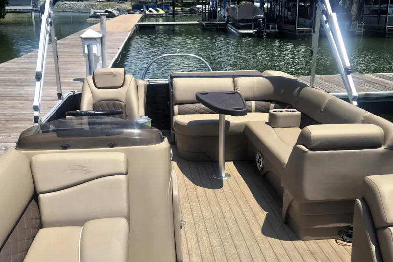 Slide: The Image of 2019 Bennington SX 22 SLX pontoon boat with beige seating, docked by the water. - 11