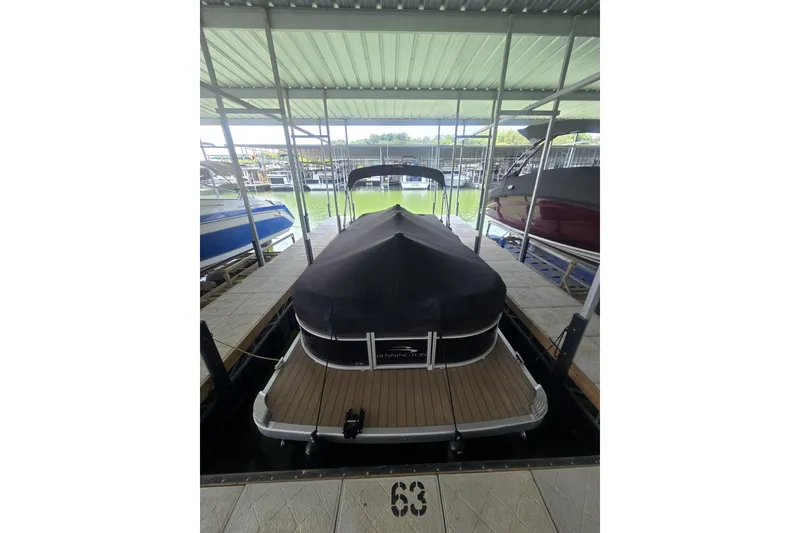 Slide: The Image of 2019 Bennington SX 22 SLX pontoon boat docked with cover in marina. - 3