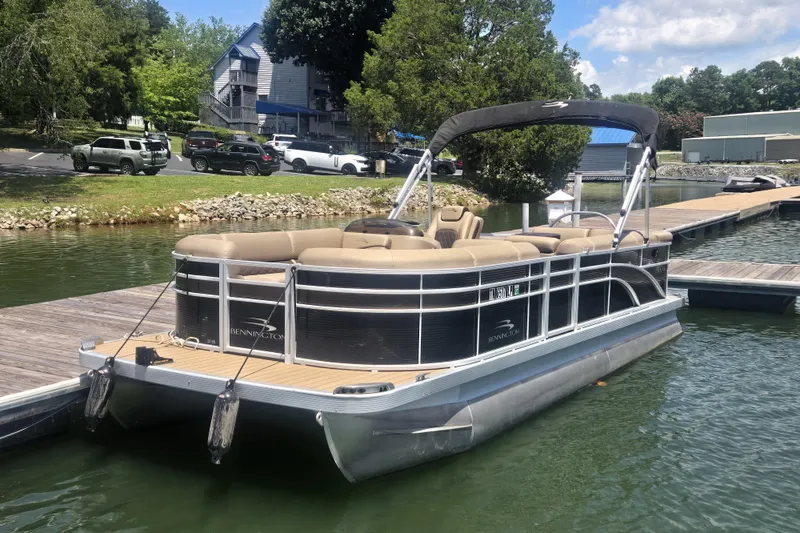 Slide: The Image of 2019 Bennington SX 22 SLX pontoon boat docked on a sunny day. - 1