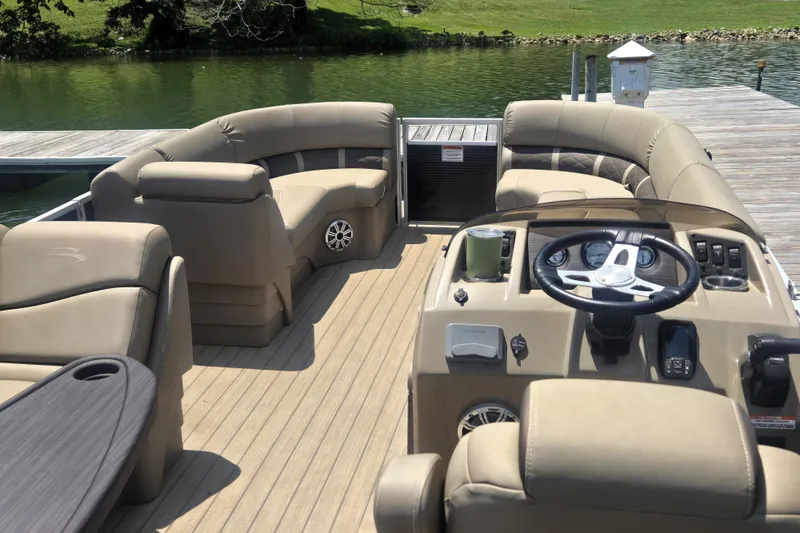 Slide: The Image of 2019 Bennington SX 22 SLX pontoon boat interior with plush seating and steering console. - 8