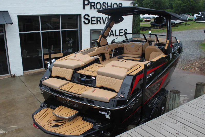 Slide: The Image of 2026 Tigé 24RZX boat with luxurious seating, displayed at a dealership. - 3