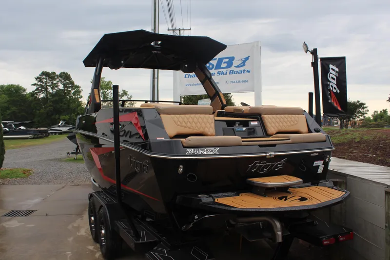 Slide: The Image of 2026 Tigé 24RZX boat with tan seating, displayed outdoors on a trailer. - 6