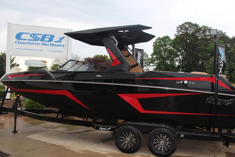 Slide: The Image of 2026 Tigé 24RZX boat in black and red at Charlotte Ski Boats dealership. - 7