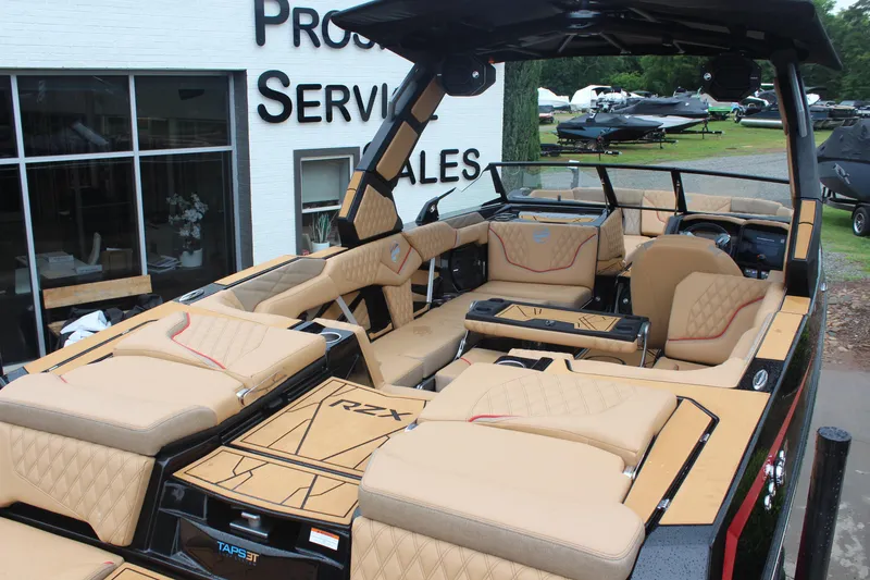 Slide: The Image of 2026 Tigé 24RZX boat with luxurious tan interior at dealership. - 4