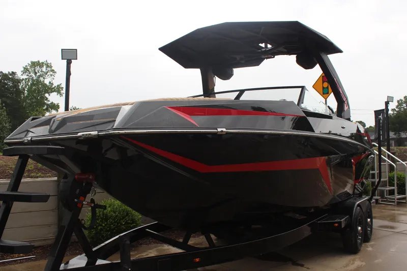 Slide: The Image of 2026 Tigé 24RZX boat with sleek black and red design on a trailer. - 8
