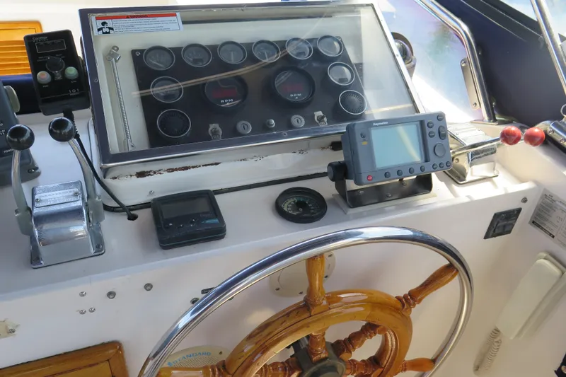 Slide: The Image of 1987 Hershine Aftcabin Motoryacht cockpit with steering wheel and navigation instruments. - 8