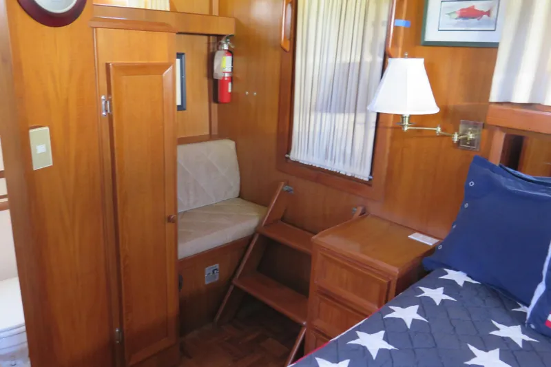 Slide: The Image of 1987 Hershine Aftcabin Motoryacht interior with wood paneling, bed, and nautical decor. - 36
