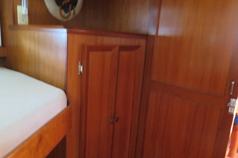 Slide: The Image of 1987 Hershine Aftcabin Motoryacht interior with wooden cabinetry and bed. - 31