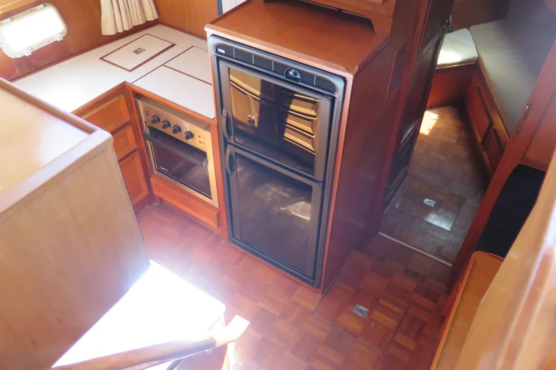 Slide: The Image of 1987 Hershine Aftcabin Motoryacht kitchen with wood cabinetry and appliances. - 26