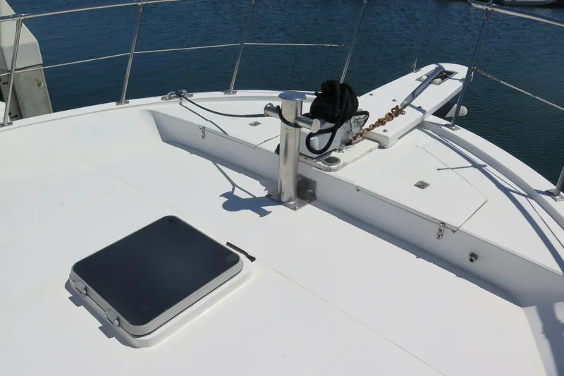 Slide: The Image of 1987 Hershine Aftcabin Motoryacht deck with hatch and railing, docked by water. - 4