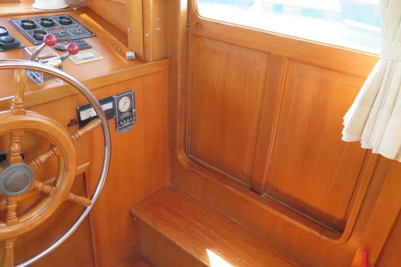 Slide: The Image of 1987 Hershine Aftcabin Motoryacht cockpit with wooden steering wheel and control panel. - 21