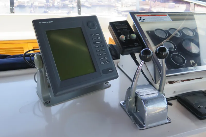 Slide: The Image of Control panel of a 1987 Hershine Aftcabin Motoryacht with navigation equipment and throttle levers. - 7