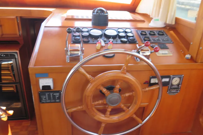 Slide: The Image of 1987 Hershine Aftcabin Motoryacht cockpit with wooden steering wheel and control panel. - 20