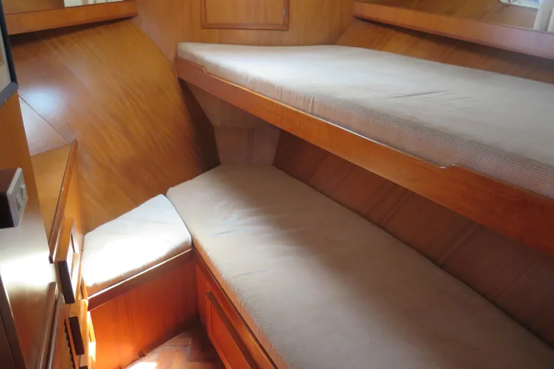 Slide: The Image of 1987 Hershine Aftcabin Motoryacht interior with wooden bunk beds and cozy cabin design. - 29