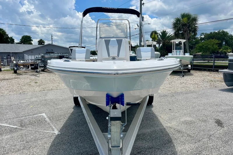 Slide: The Image of 2024 Robalo 206 Cayman boat on trailer, displayed outdoors under a partly cloudy sky. - 3