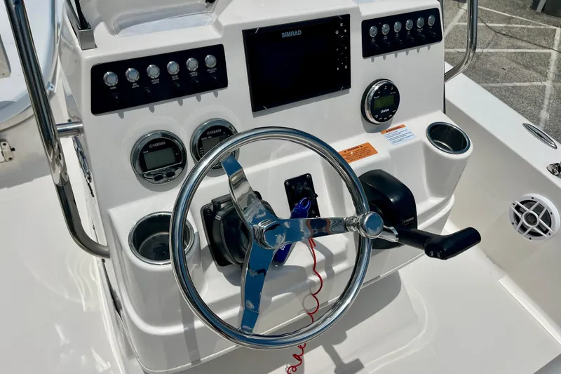 Slide: The Image of 2024 Robalo 206 Cayman boat dashboard with steering wheel and control panel. - 21