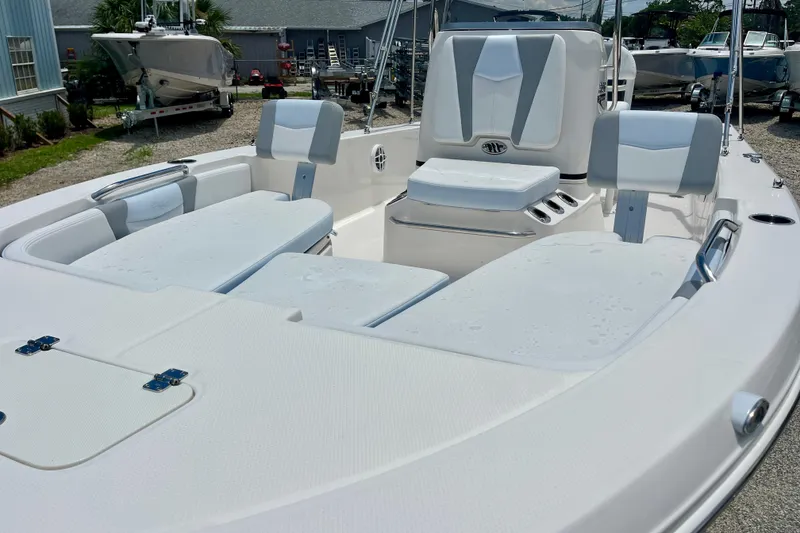 Slide: The Image of 2024 Robalo 206 Cayman boat interior with cushioned seating and sleek design. - 10