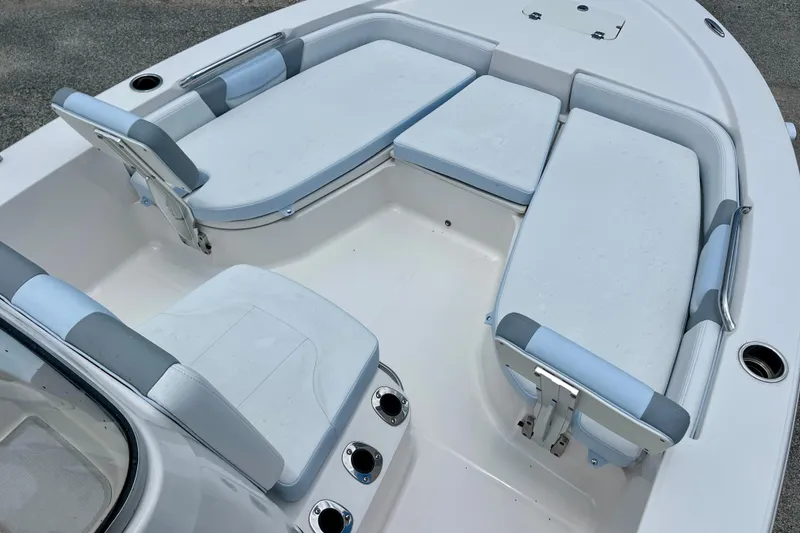 Slide: The Image of 2024 Robalo 206 Cayman boat interior with cushioned seating and cup holders. - 17