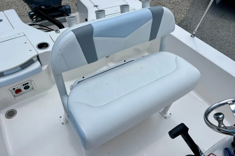 Slide: The Image of 2024 Robalo 206 Cayman boat interior with cushioned seating and steering wheel. - 16