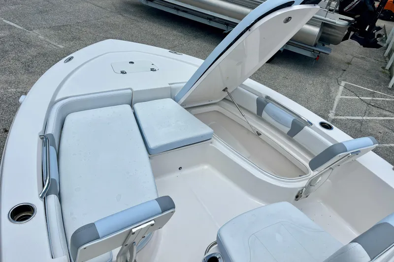 Slide: The Image of 2024 Robalo 206 Cayman boat interior with open storage compartment and seating. - 18